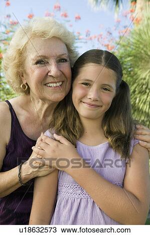 Girl (7-9) with Grandmother outdoors, front view portrait. View Large Photo Image Stock Image - Girl (7-9) with Grandmother outdoors, front view portrait.. Fotosearch