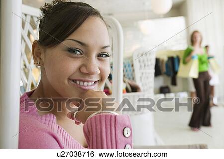 Stock Photograph - Girl Hanging Out in Boutique, portrait, close up. Fotosearch
