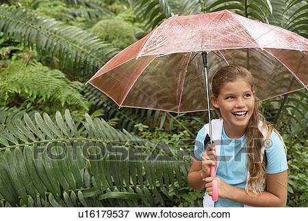 Girl Holding Umbrella in Forest View Large Photo Image Stock Photo - Girl Holding Umbrella in Forest. Fotosearch