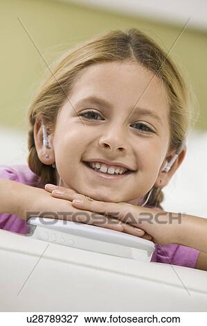 Stock Photo - Girl Listening to Portable CD Player. Fotosearch