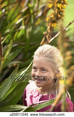 Stock Photography - Girl Looking at Plants. Fotosearch