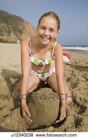 Girl Playing in Sand at Beach View Large Photo Image Stock Photo - Girl Playing in Sand at Beach. Fotosearch
