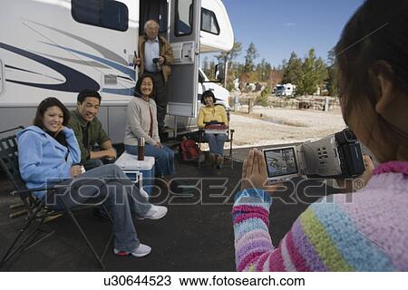 Girl videotaping family outside of RV View Large Photo Image Stock Image - Girl videotaping family outside of RV. Fotosearch