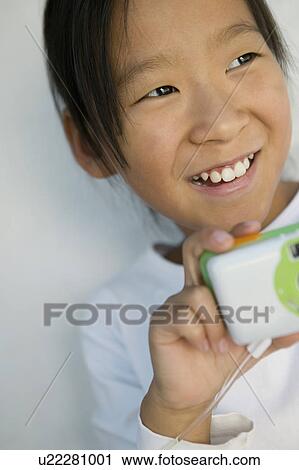 Stock Image - Girl with Camera, close up. Fotosearch
