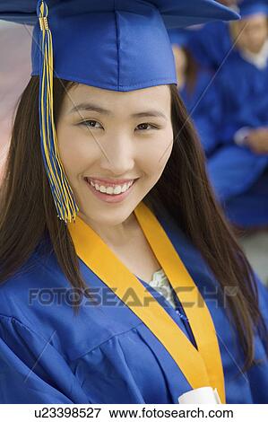 Stock Photo - Graduate outdoors, elevated view, portrait. Fotosearch