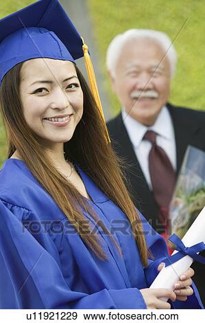 Graduate with Grandfather behind, outside, portrait View Large Photo Image Stock Photo - Graduate with Grandfather behind, outside, portrait. Fotosearch