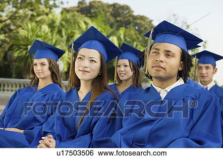Graduates listening to ceremony outside View Large Photo Image Stock Photograph - Graduates listening to ceremony outside. Fotosearch