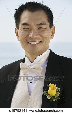 Groom smiling outdoors, (portrait) View Large Photo Image Stock Image - Groom smiling outdoors, (portrait). Fotosearch