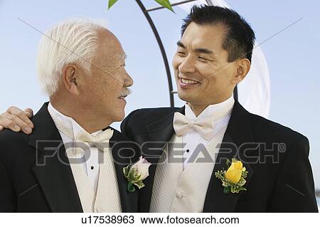 Stock Image - Groom with father, outdoors, (close-up). Fotosearch