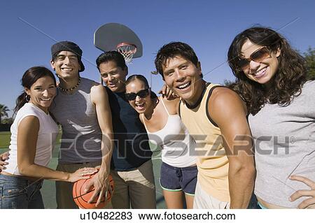 Group of young adults at basketball court. View Large Photo Image Stock Image - Group of young adults at basketball court.. Fotosearch