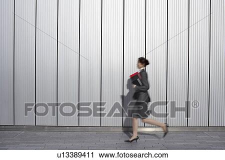 hurrying Businesswoman running past building, side view View Large Photo Image Stock Image - hurrying Businesswoman running past building, side view. Fotosearch