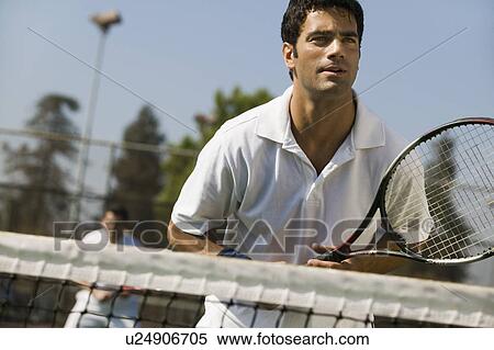 Stock Photography - Male doubles tennis players waiting for serve, front view, focus on foreground. Fotosearch