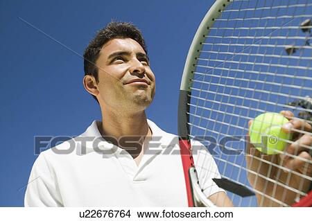 Male Tennis Player Preparing to Serve, close up, low angle view View Large Photo Image Picture - Male Tennis Player Preparing to Serve, close up, low angle view. Fotosearch