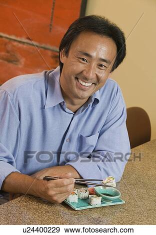 Man Eating Sushi, portrait View Large Photo Image Stock Photo - Man Eating Sushi, portrait. Fotosearch