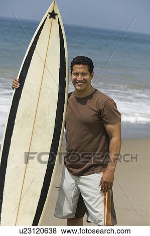 Stock Photo - Man Holding Surfboard. Fotosearch