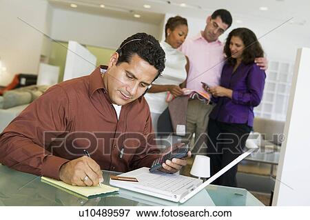 Man in furniture store adding figures with calculator, laptop and notepad in furniture store View Large Photo Image Stock Photo - Man in furniture store adding figures with calculator, laptop and notepad in furniture store. Fotosearch