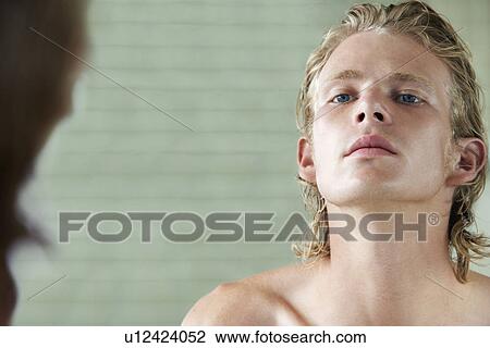Man looking at mirror in bathroom View Large Photo Image Stock Image - Man looking at mirror in bathroom. Fotosearch