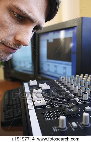 Man looking at mixer, close-up. View Large Photo Image Picture - Man looking at mixer, close-up.. Fotosearch