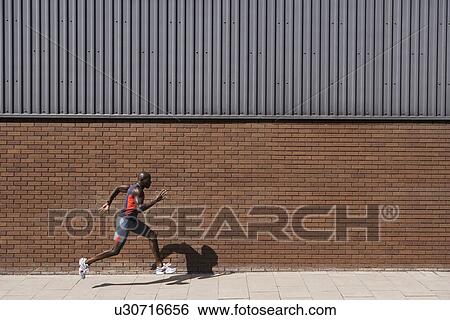 Man running past brick wall View Large Photo Image Stock Photograph - Man running past brick wall. Fotosearch