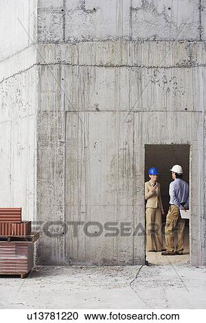 Managers talking at construction site View Large Photo Image Stock Image - Managers talking at construction site. Fotosearch