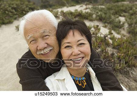 Mature couple embracing at beach, smiling, (portrait) View Large Photo Image Stock Image - Mature couple embracing at beach, smiling, (portrait). Fotosearch