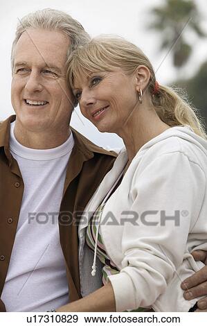 Stock Photo - Mature couple embracing outdoors. Fotosearch