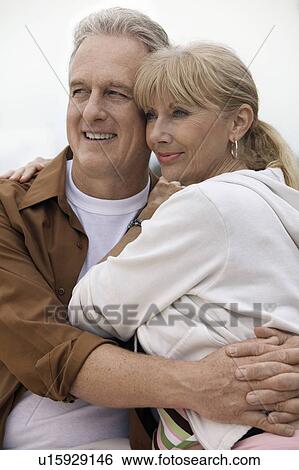 Mature couple embracing outdoors View Large Photo Image Stock Photograph - Mature couple embracing outdoors. Fotosearch
