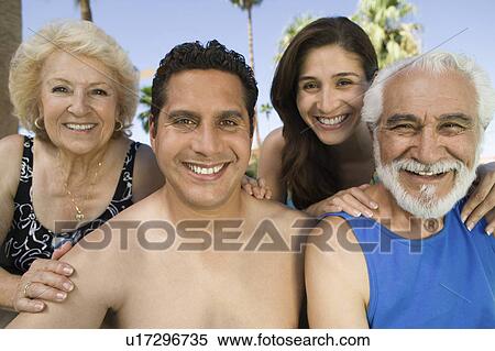 Stock Photography - Mid-adult couple and senior couple outdoors, front view portrait.. Fotosearch