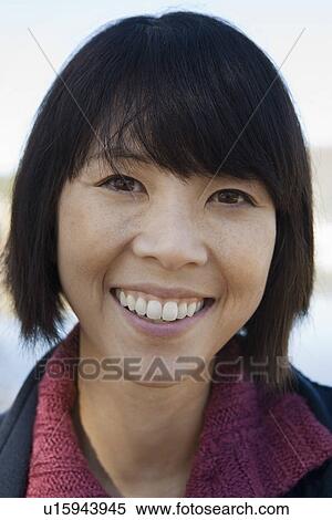 Stock Photography - Mid-adult woman smiling outdoors, portrait. Fotosearch