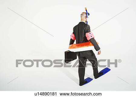 Middle-aged businessman in flippers, inflatable rubber ring, snorkel and goggles walking, carrying briefcase View Large Photo Image Stock Image - Middle-aged businessman in flippers, inflatable rubber ring, snorkel and goggles walking, carrying briefcase. Fotosearch
