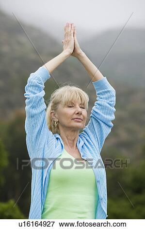Middle-aged woman practicing yoga View Large Photo Image Stock Photo - Middle-aged woman practicing yoga. Fotosearch