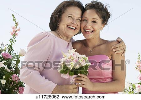 Stock Image - Mother and Bride with bouquet, outdoors, (portrait). Fotosearch