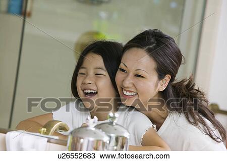 Mother and Daughter Looking at reflection in Bathroom mirror, focus on mirror View Large Photo Image Stock Image - Mother and Daughter Looking at reflection in Bathroom mirror, focus on mirror. Fotosearch