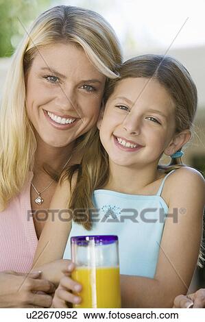 Stock Image - Mother and Daughter Sitting on Patio. Fotosearch