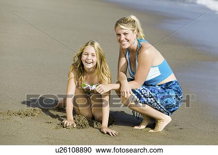 Stock Image - Mother and Daughter Together on Beach. Fotosearch