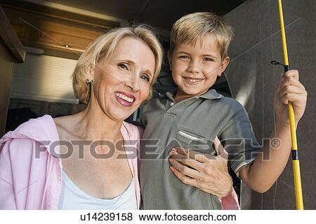 Stock Photo - Mother with Son Holding Fishing Rod. Fotosearch