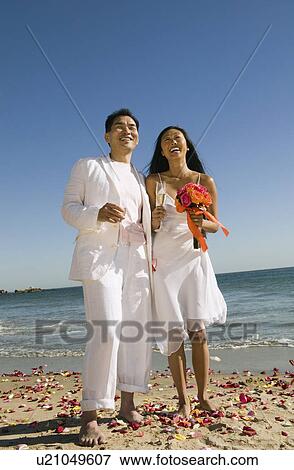 Stock Photo - Newly wed couple on beach. Fotosearch