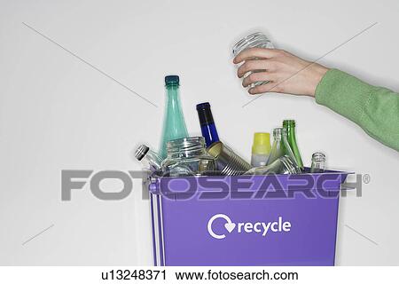 Person putting jar into recycling container filled with empty glass vessels View Large Photo Image Stock Image - Person putting jar into recycling container filled with empty glass vessels. Fotosearch