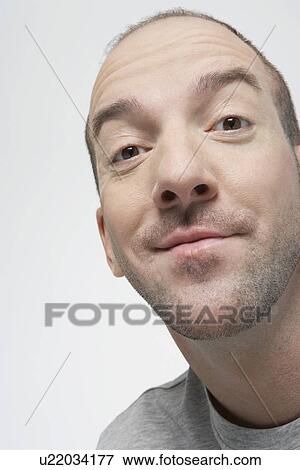 Stock Photo - Satisfied-looking man, close-up. Fotosearch