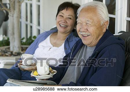 Senior couple drinking tea on porch, smiling View Large Photo Image Stock Photo - Senior couple drinking tea on porch, smiling. Fotosearch