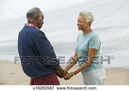 Senior couple holding hands on beach View Large Photo Image Stock Photo - Senior couple holding hands on beach. Fotosearch