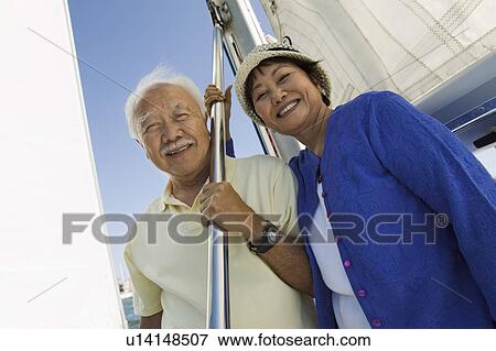 Senior couple on sailboat, (portrait) View Large Photo Image Stock Photo - Senior couple on sailboat, (portrait). Fotosearch