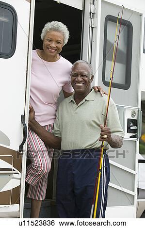 Senior couple on steps of a caravan View Large Photo Image Stock Photograph - Senior couple on steps of a caravan. Fotosearch
