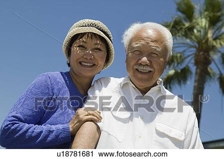 Senior couple smiling outdoors, (portrait) View Large Photo Image Stock Image - Senior couple smiling outdoors, (portrait). Fotosearch
