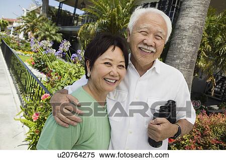 Senior couple with binoculars, smiling, outdoors, (portrait) View Large Photo Image Stock Photography - Senior couple with binoculars, smiling, outdoors, (portrait). Fotosearch