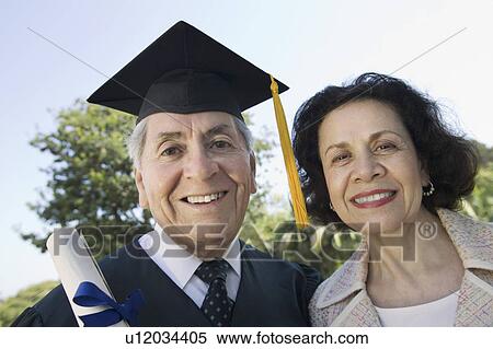 Stock Photography - Senior graduate and wife outside, portrait. Fotosearch
