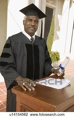Stock Image - Senior graduate at podium outside, portrait. Fotosearch
