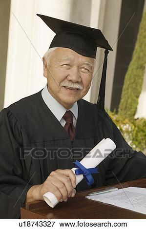 Stock Photo - Senior graduate at podium outside, portrait. Fotosearch