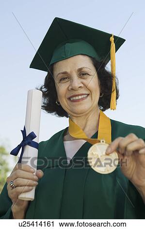 Senior Graduate holding diploma and medal outside, portrait View Large Photo Image Stock Image - Senior Graduate holding diploma and medal outside, portrait. Fotosearch