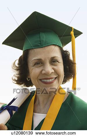 Senior Graduate holding diploma outside, portrait View Large Photo Image Stock Photo - Senior Graduate holding diploma outside, portrait. Fotosearch
